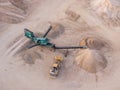 Aerial view of a quarry with conveyor belt and wheel loader - stones and sands for construction - top view , open pit mine, extrac