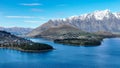 Aerial view of Queenstown town at the southern end of Lake Wakatipu with a backdrop of the snow capped Remarkables Mountain range