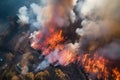 aerial view of raging wildfire, with firefighters in full gear battling the flames