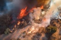 aerial view of raging wildfire, with firefighters in full gear battling the flames