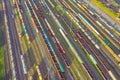 Aerial view of rail sorting freight station with railway cars, with many rail tracks railroad. Heavy industry landscape on evening Royalty Free Stock Photo
