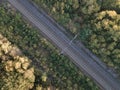 Aerial view railroad in autumn forest in foggy sunrise. Top view rural railway