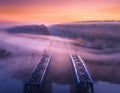 Aerial view of railroad bridge in fog at sunrise in autumn Royalty Free Stock Photo