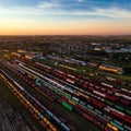Aerial view of the railway junction with freight trains at sunset