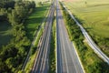 Aerial view, railway and road in rural landscape.