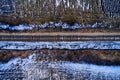 Aerial view of railway track through countryside in winter, drone pov