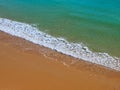 Aerial view of red beach sand with blue ocean and waves Royalty Free Stock Photo