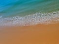 Aerial view of red beach sand with blue ocean and waves Royalty Free Stock Photo