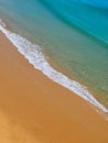 Aerial view of red beach sand with blue ocean and waves Royalty Free Stock Photo