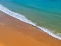 Aerial view of red beach sand with blue ocean and waves Royalty Free Stock Photo