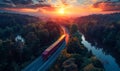 Aerial view of red bus traveling through the forest on the asphalt road in the rural landscape at sunset. Imagens Royalty Free Stock Photo