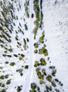 Aerial view of red car driving through the white snow winter forest on country road in Finland, Lapland Royalty Free Stock Photo