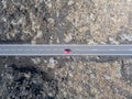 Aerial view of a red car on a road that runs through lava fields of Lanzarote, Canary Islands, Spain Royalty Free Stock Photo