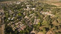 Aerial view of red houses rooftops with green grass and trees in the suburb Royalty Free Stock Photo