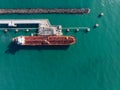 Aerial view of an red oil tanker at jetty.