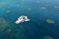 Aerial view of reef with marine diving platform and boats at the
