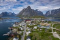 Aerial view of Reine, Lofoten islands, Norway. The fishing village of Reine. Spring time in Nordland. Blue sky. View from above