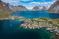 Aerial view of Reine, Lofoten islands, Norway. The fishing village of Reine. Spring time in Nordland. Blue sky. View from above