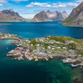 Aerial view of Reine, Lofoten islands, Norway. The fishing village of Reine. Spring time in Nordland. Blue sky. View from above