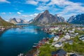 Aerial view of Reine, Lofoten islands, Norway. The fishing village of Reine. Spring time in Nordland. Blue sky. View from above