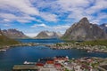 Aerial view of Reine, Lofoten islands, Norway. The fishing village of Reine. Spring time in Nordland. Blue sky. View from above