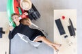 Aerial view of relaxed employee female holding passport ready to travel in workplace of office. Summer vacations concept Royalty Free Stock Photo