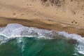 Aerial view of a remote sandy beach and sea waves Royalty Free Stock Photo