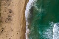 Aerial view of a remote sandy beach and sea waves Royalty Free Stock Photo