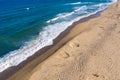 Aerial view of a remote sandy beach and sea waves Royalty Free Stock Photo