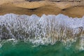 Aerial view of a remote sandy beach and sea waves Royalty Free Stock Photo