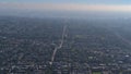 Aerial view of residential districts in southern Vancouver, Canada on hazy day with streets and houses and cloudy sky.