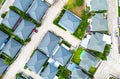 Aerial view of residential houses and driveways neighborhood during a fall sunset or sunrise time. Tightly packed homes. Royalty Free Stock Photo