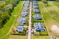 Aerial view of residential houses neighborhood and apartment building complex at sunset. Tightly packed homes, driveway surrounds Royalty Free Stock Photo