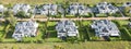 Aerial view of residential houses neighborhood and apartment building complex at sunset. Tightly packed homes, driveway surrounds Royalty Free Stock Photo