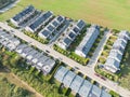 Aerial view of residential houses neighborhood and apartment building complex at sunset. Tightly packed homes, driveway surrounds Royalty Free Stock Photo