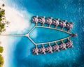 Aerial view of a a resort in Fushifaru Maldives with overwater bungalows
