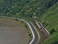 Aerial view of Rhine riverbank with railroad tracks and InterCity Express train of Deutsche Bahn passing cars on street. Royalty Free Stock Photo