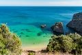 Cliff at Ribeiro do Cavalo beach, with clear water and rocks, Sesimbra PORTUGAL