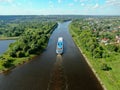 Aerial view river cruise ship sails along the river surrounded by beautiful green forest in summer on a sunny day Cruise Ship Trip Royalty Free Stock Photo