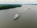 Aerial view river cruise ship sails along the river surrounded by beautiful green forest in summer on a sunny day Cruise Ship Trip Royalty Free Stock Photo