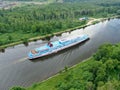 Aerial view river cruise ship sails along the river surrounded by beautiful green forest in summer on a sunny day Cruise Ship Trip Royalty Free Stock Photo