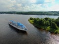 Aerial view river cruise ship sails along the river surrounded by beautiful green forest in summer on a sunny day Cruise Ship Trip Royalty Free Stock Photo