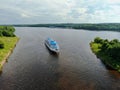 Aerial view river cruise ship sails along the river surrounded by beautiful green forest in summer on a sunny day Cruise Ship Trip Royalty Free Stock Photo