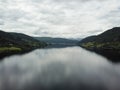 Aerial view of a river flowing through the Norwegian fjord mountains on a rainy cloudy day Royalty Free Stock Photo