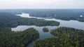 Aerial view of a river in a forest landscape in Loch Raven with a misty sky