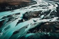 an aerial view of a river running through a mountain range in the mountains of alaska, with blue water flowing from the river to Royalty Free Stock Photo