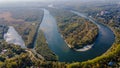 Aerial view of the river`s loop near the forest durin early autumn time