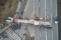 Aerial view of road accident with overturned truck blocking traffic