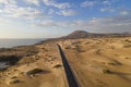 view of a road along the coast crossing the Sand Dune Natural Park in Corralejo, Fuerteventura, Canary Islands, Spain Royalty Free Stock Photo