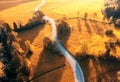 Aerial view of road in alpine meadows at sunset in autumn Royalty Free Stock Photo